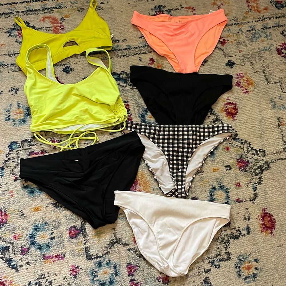 Multiple bathing suit tops and bottoms